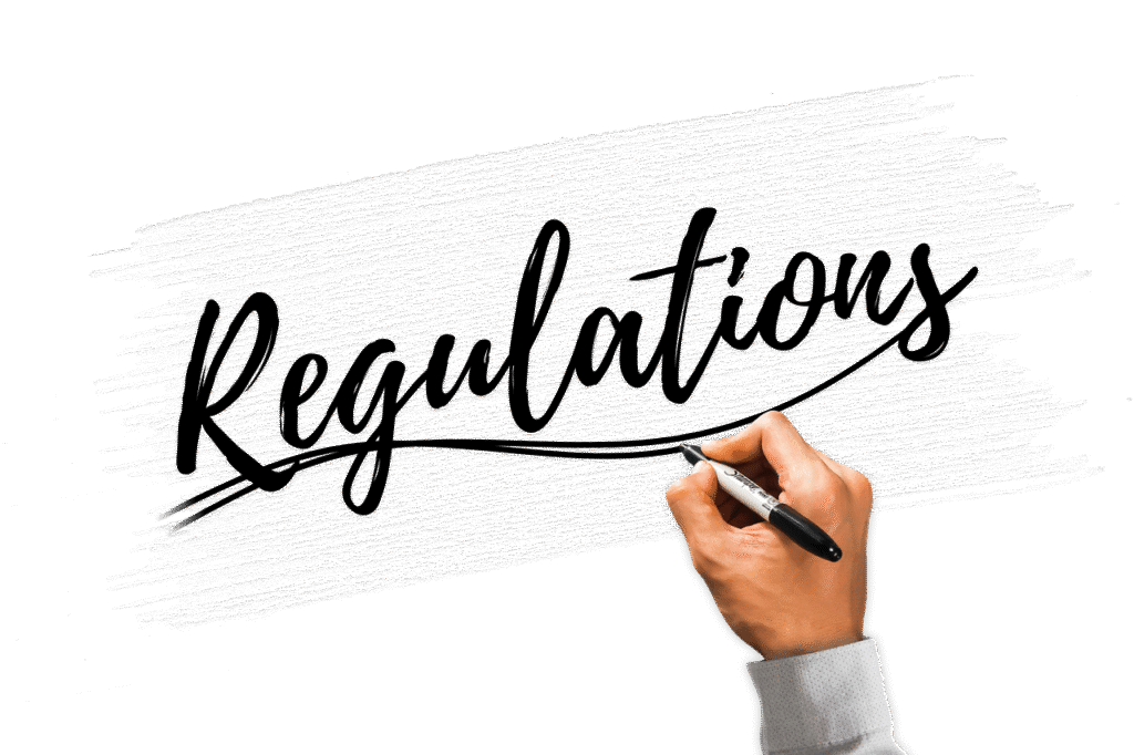 A picture of a hand holding a pen with the word Regulations written on the canvas